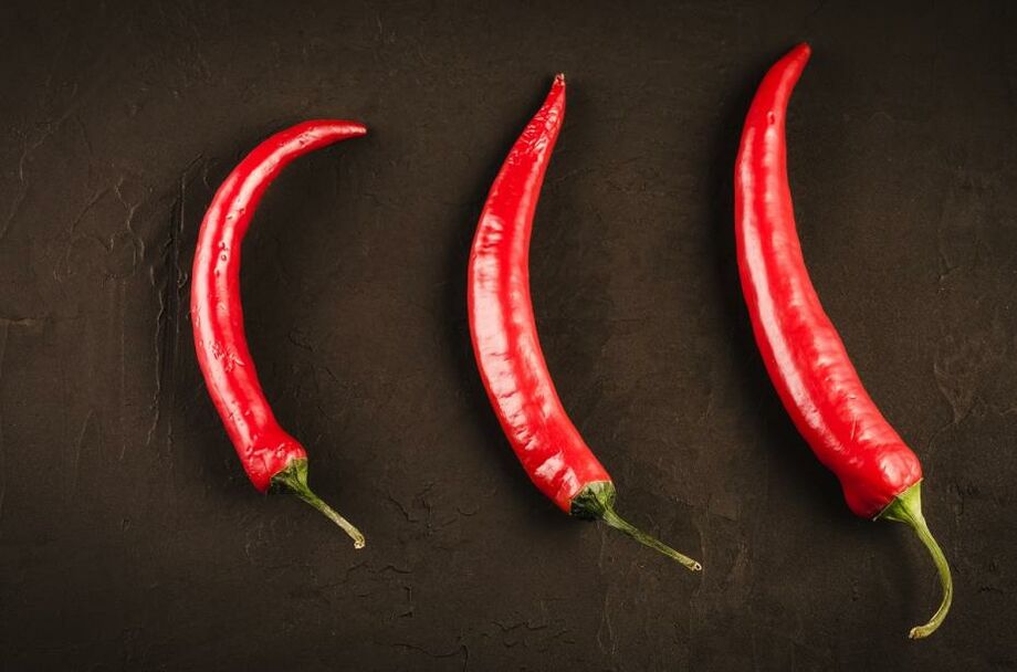 Three red Chile pepper on a dark background/Three red hot Chile