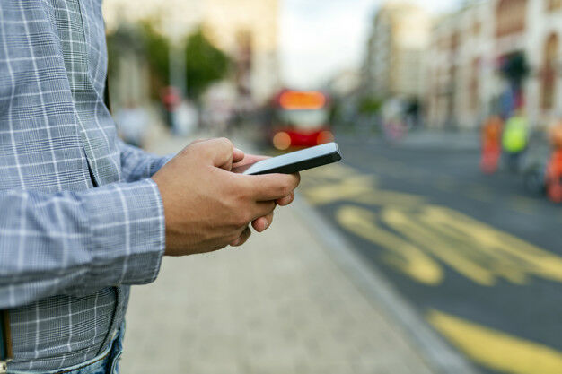 Man on the Street with Phone in Hands