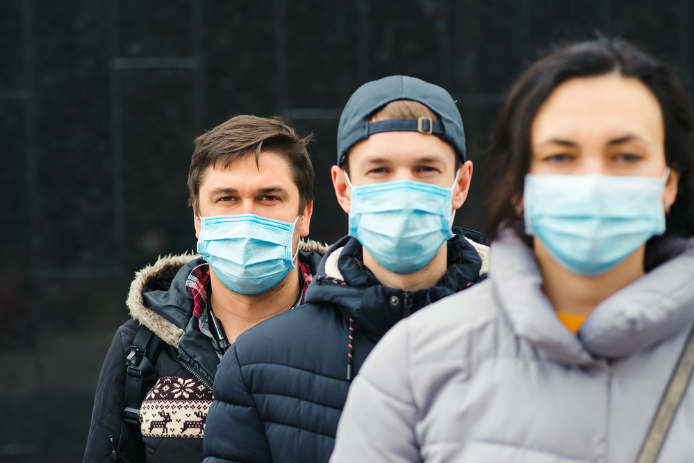 Coronavirus epidemic. People wearing face mask outdoors. Group of young volunteers. Coronavirus quarantine.