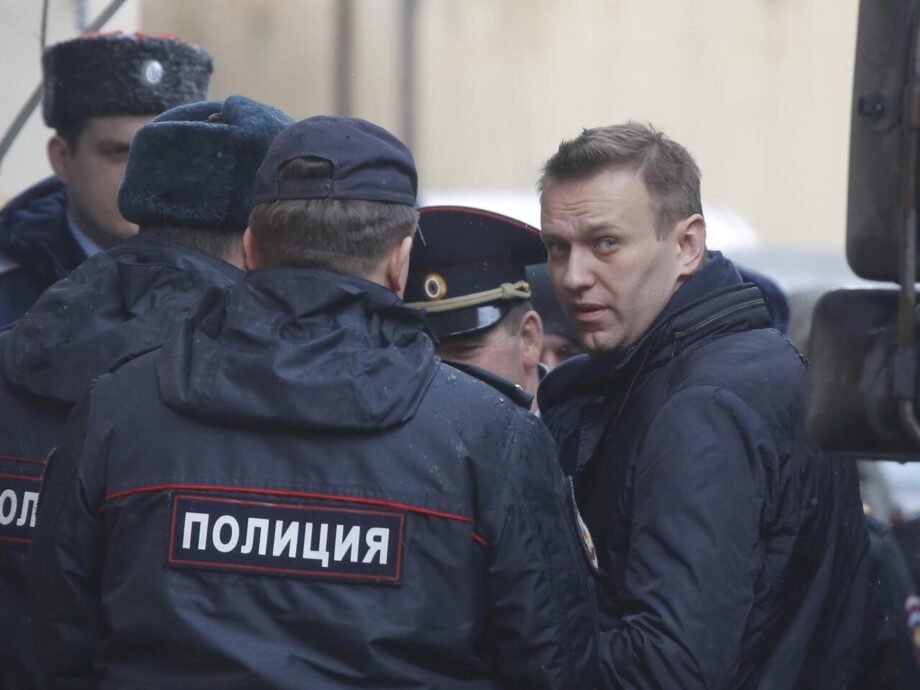 Russian opposition leader Navalny is escorted upon his arrival for hearing after being detained at protest against corruption and demanding resignation of PM Medvedev, at Tverskoi court in Moscow