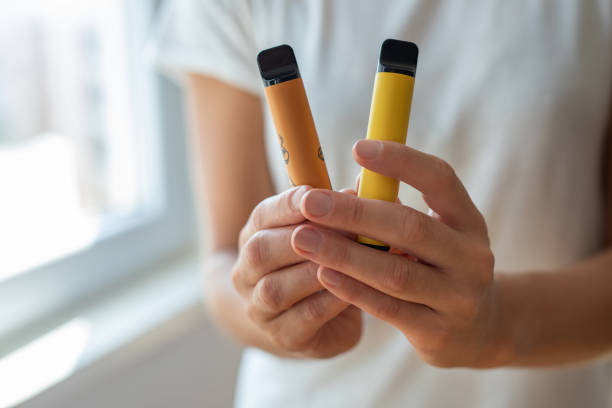 Electronic cigarette in a woman’s hand