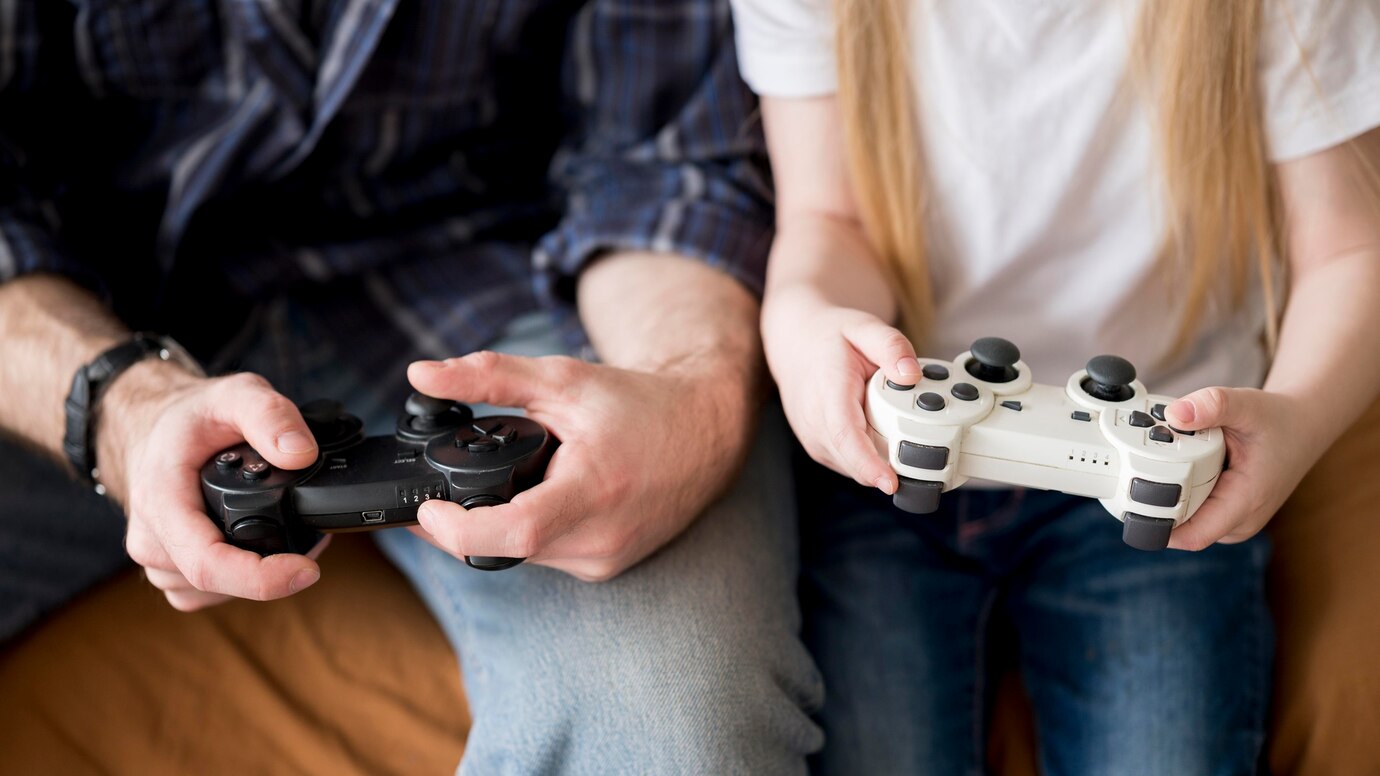 close-up-kid-father-playing-with-joystick_23-2148514524